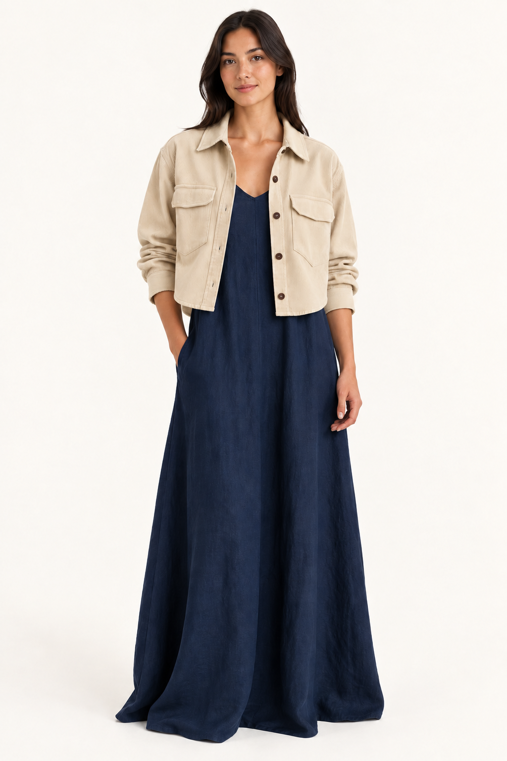 Cream cord overshirt layered over navy maxi dress, shorter hem