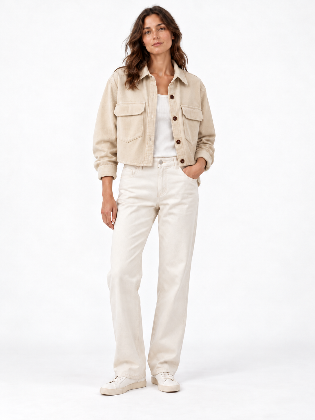 Model wearing the shorter, gently cropped cream cord overshirt with cream trousers